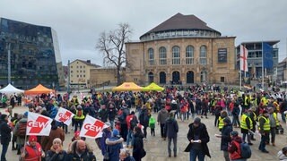 Zahlreiche Menschen mit Fahnen und Warnwesten stehen auf dem Platz der Alten Synagoge in Freiburg.