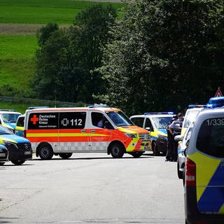 Rettungsdienste und Polizei stehen an einer Straße bei einem Einsatz in Albstadt-Lautlingen.