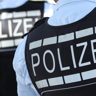 Die Aufschrift "Polizei" ist auf der Uniform von Polizisten zu sehen.