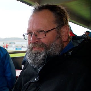 Ein bärtiger Mann mit Brille. Fußballtourist Claus "Bredi" Breitenberger ist der wohl größte Fan im Amateurfußball in der Region Ostwürttemberg. Hier besucht er ein Spiel in Dorfmerkingen.