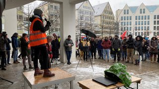 Eine junge Frau steht mit einem Mikrofon vor eine Menschenmenge. Am Samstagnachmittag hat Fridays for Future UlmNeu-Ulm zu einer Demonstration auf dem Münsterplatz aufgerufen. 