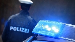 Polizist im Einsatz und Blaulicht