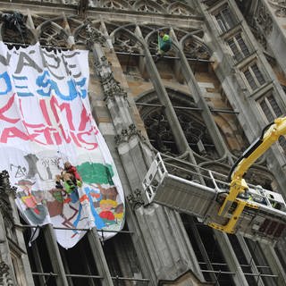 Hebebühne am Ulmer Münster. Mit einer Hebebühne sind Klimaaktivisten am Dienstag vom Turm des Ulmer Münsters gebracht worden. Sie hatten Dienstagfrüh am Turm ein großes Banner aufgehängt, mit der Frage : " Wäre Jesus Klimaaktivist?"