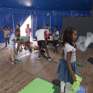 Kinder lernen artistische Übungen in einer Familienferienstätte.
