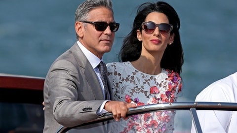 George Clooney (L) and his wife Amal Alamuddin (R