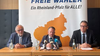 Der Landesvorsitzende der Freien Wähler Rheinland-Pfalz, Stephan Wefelscheid (M), Parteivize Herbert Drumm (l) und Schatzmeister Marco Degen äußern sich zu den Beweggründen ihres angekündigten Abschieds aus dem Landesvorstand. 