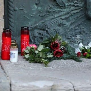 Kerzen und Blumen liegen vor der Johanneskirche in Magdeburg. Sie wurde nach dem Attentat am Freitagabend, als ein Autofahrer in eine Menschengruppe raste und fünf Menschen starben, zum offiziellen Trauerort. Auch Rheinland-Pfalz trauert mit den Opfern.  