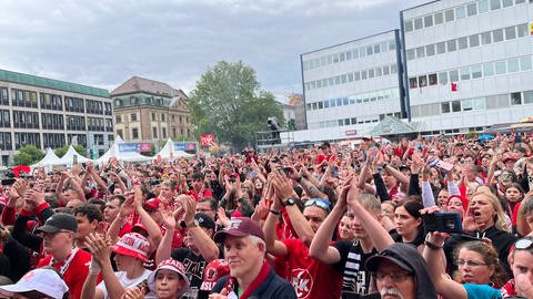FCK-Fans bejubeln auf dem Stiftsplatz in Kaiserslautern die Mannschaft.