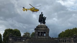 Rettungshubschrauber Christoph 23 aus Koblenz fliegt über dem Kaiserdenkmal am Deutschen Eck.