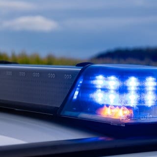 Das Blaulicht eines Polizeiautos leuchtet. 