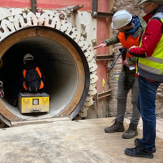 SWR-Reporterin Nada Fiebes "fährt" auf einer Art Schlitten durch den neuen Tunnel unter dem Rhein in Koblenz. 