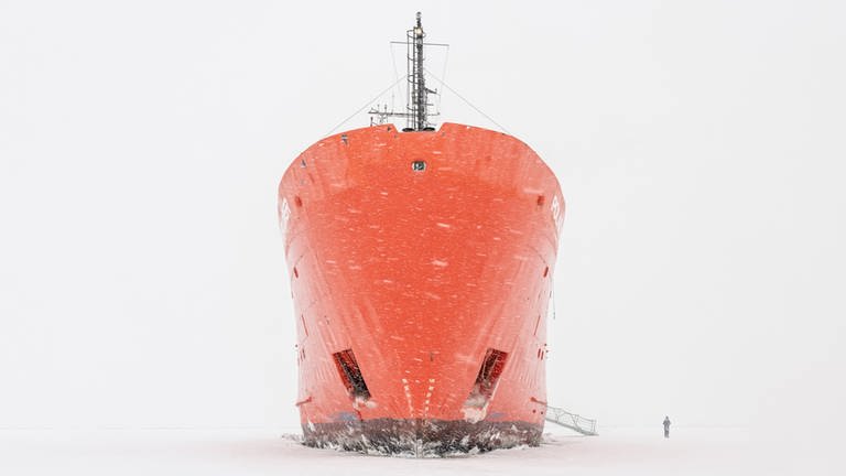 Das Kunstwerk "Icebreaker"von Uwe Langmann zeigt einen großen roten Eisbrecher vor weißem Hintergrund. Es wird bei den Kunsttagen 2024 in Winningen in der Vinothek im Spital gezeigt. 