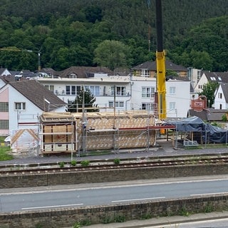 In Einzelteile zerlegt wird das Bahnhofsgebäude von Walporzheim mithilfe eines Schwerlastkrans abtransportiert.