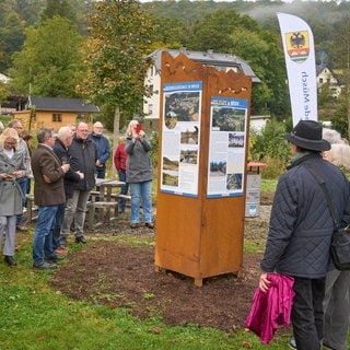 Bürger betrachten am 12. Oktober 2024 eine Stele zur Flutkatastrohe, die von der Bürgerinitiative "MemoriAHR", enthüllt wurde. Ein Weg der Erinnerung soll von der Quelle bis zur Mündung der Ahr und durch alle Orte führen, die von der Flutkatastrophe im Ahrtal betroffen waren.