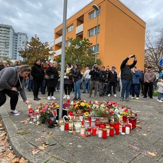Menschen gedenken in Ludwigshafen-Oggersheim an die Opfer der Messerattacke.