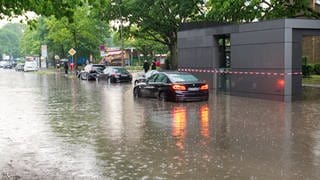 Autos stehen auf einer überfluteten Straße - Sujetbild