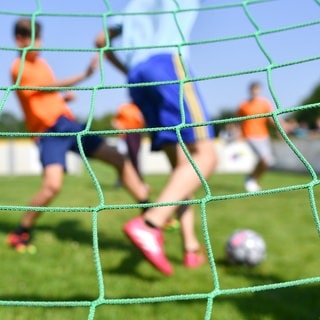 Kinder spielen Fußball auf einem Fußballplatz