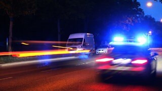 Die Polizei fährt nachts mit einem Einsatzfahrzeug durch Mainz. 