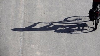 Fahrrad mit langem Schatten. Der Radfahrer war auf der Autobahn bei Bad Kreuznach unterwegs. 