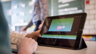 Schülerinnen und Schüler nehmen im Klassenzimmer einer 9. Klasse am Unterricht mit Hilfe von Laptops und Tablets teil: In Schulen der Region Trier fehlt es häufig an Laptops und Beamern für den digitalen Unterricht. 