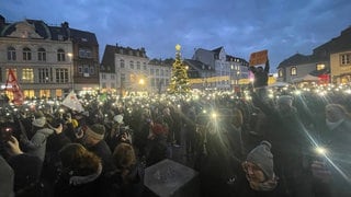 Mit Lichtern setzen die Menschen an der Porta Nigra in Trier zum Abschluss der Demo gegen noch ein Zeichen gegen Rechts wie bei vielen anderen Demos auch.