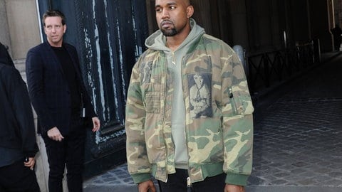 Kanye West is wearing a bomber jacket by Raf Simons