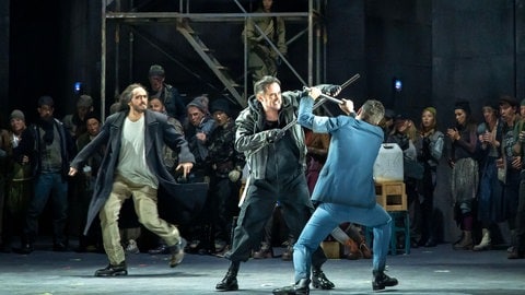 Verdis Oper "Otello" am Theater Ulm: Otello (Rodrigo Porras Garulo) versucht, Cassio (Markus Francke) und Montano (Martin Gäbler) vom Kampf abzuhalten.