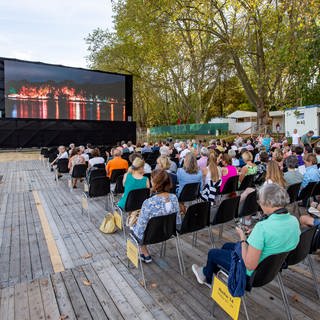 Festivalbesucher schauen sich im Freiluftkino des 18. Festivals des Deutschen Films einen Film an.