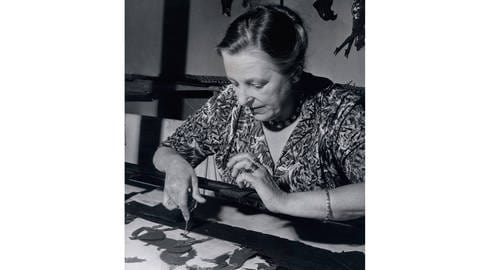 Lotte Reiniger an ihrem Animationstisch beim Ausrichten einer ihrer Figuren (1955)