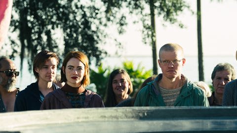 Emma Stone und Jesse Plemons laufen mit anderen Menschen auf die Kamera zu im Film KINDS OF KINDNESS