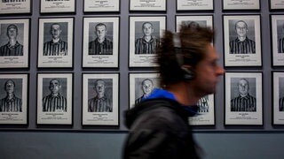 Tourist, and Photographs of prisoners of Auschwitz concentration and extermination camp Oswiecim Poland.