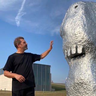 Der Künstler Ugo Rondinone steht neben einer seiner Skulpturen.