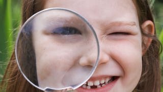 Creative Highlights Symbolfotos Girl Looking Through Magnifying Glass,model released, Symbolfoto