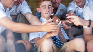 High school student offering cigarettes
