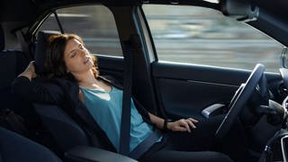 Tired businesswoman sleeping in autonomous driverless car model released, ZEDF04335