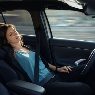 Tired businesswoman sleeping in autonomous driverless car model released, ZEDF04335