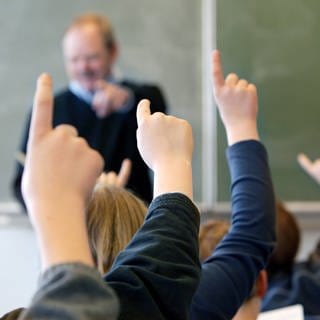 Schüler melden sich im Unterricht