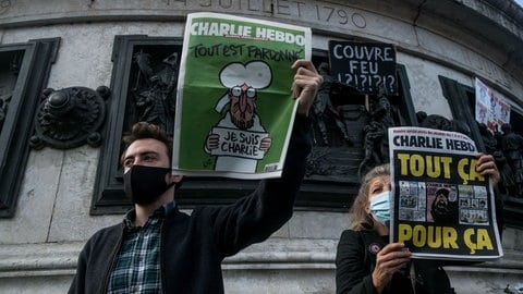 Demonstrant mit eine Zeitschrift von Charlie Hebdo