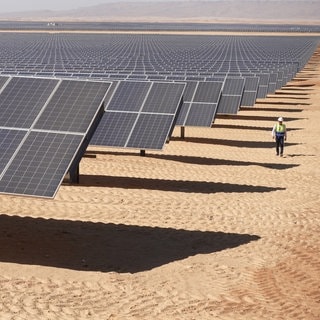 Arbeiter unterwegs im Solarpark Benban in Ägypten. Mit einer Fläche, die mehr als 50 Fußballfeldern entspricht, ist Benban inzwischen auf Satellitenfotos aus dem Weltall zu sehen.