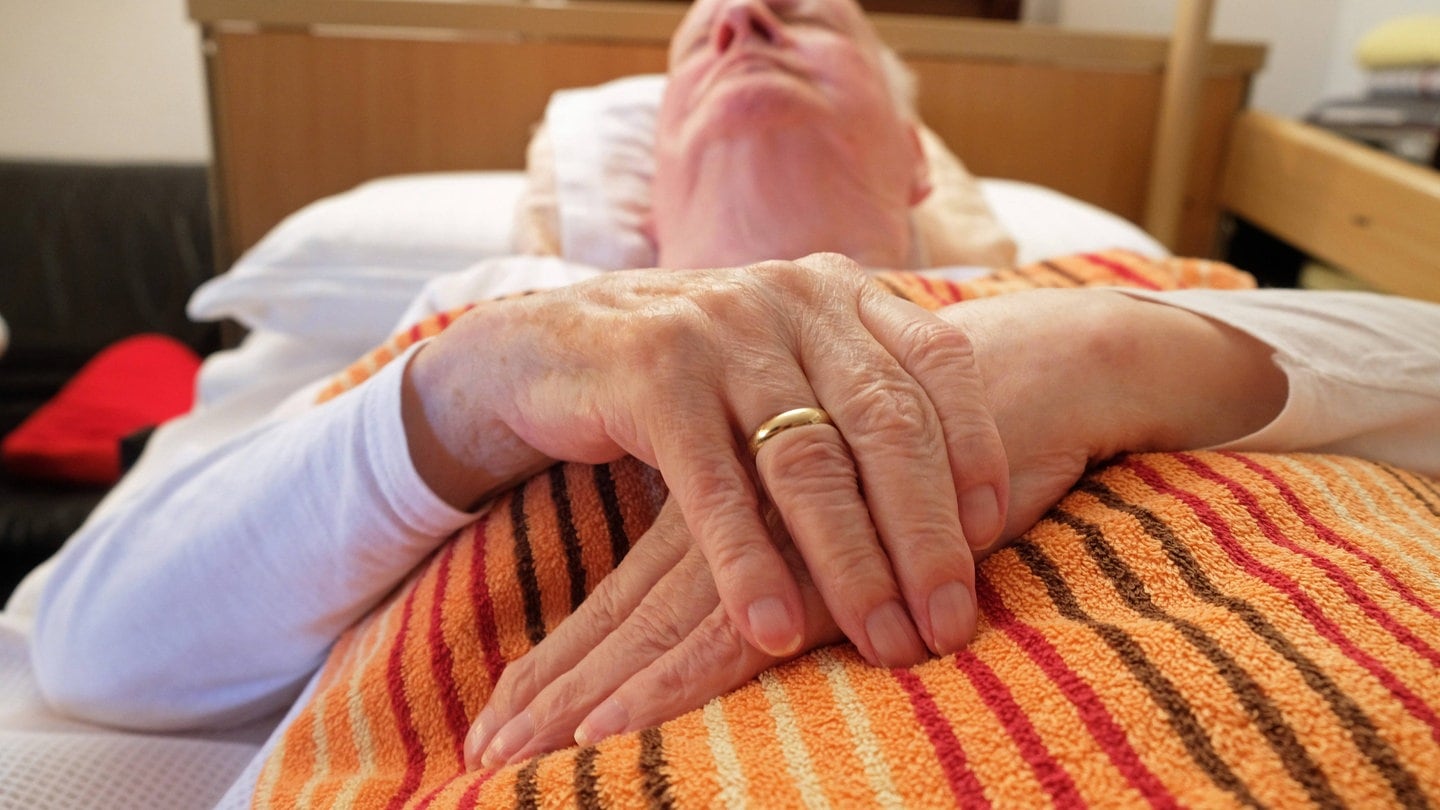 Ein alter Mann liegt im Bett: Wenn die Schmerzen unerträglich werden und keine Aussicht auf Besserung besteht, entscheiden sich manche Menschen dafür, auf Essen und Trinken zu verzichten. Das 