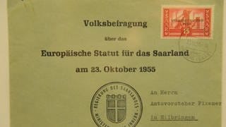 Briefumschlag. Aufschrift: Volksbefragung über das Europäische Statut für das Saarland am 23. Oktober 1955