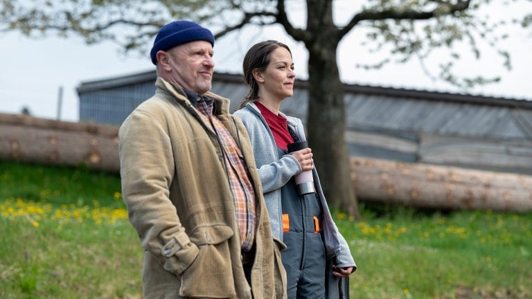 Toni und Sophie stehen hinterm Sägewerk und blicken in die Ferne