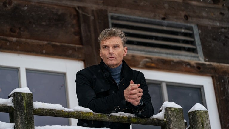 Ulrich Zimmermann (Bernd Lambrecht) auf dem Balkon seines Elternhauses, es liegt Schnee