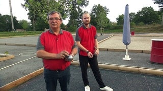 Zwei Männer spielen Petanque