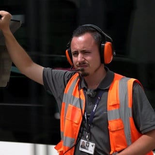 Krisztian Hertfelder ist Ramp Agent am Flughafen Stuttgart. Er trägt eine Warnweste