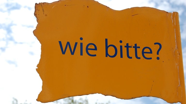 Schild mit wie bitte?