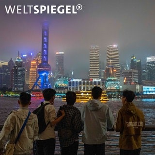 Junge Menschen vor Skyline in Shanghai am Abend