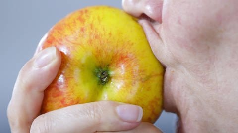 Nahaufnahme von Mund mit Apfel