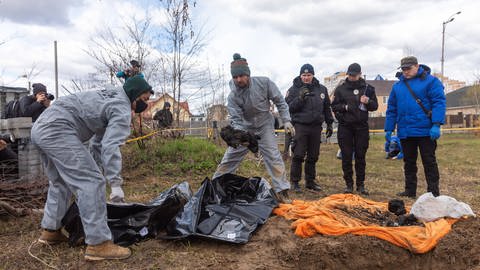 Forensische Polizisten exhumieren Leichen in Butcha, am Stadtrand von Kiew.